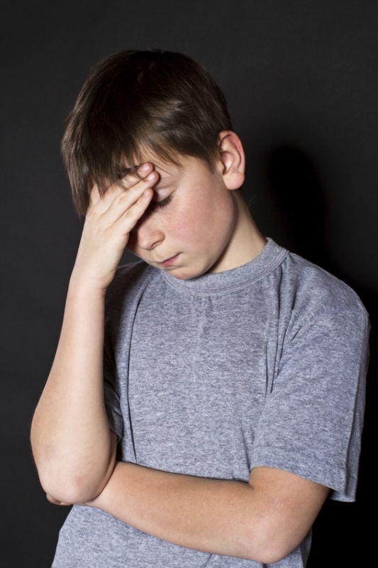 pre-teen with a severe migraine headache