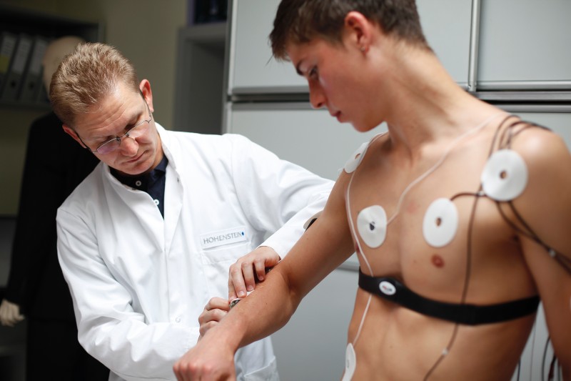 Medical proverbs: Dr. strapping an adolescent patient for what looks like a sleep study of some kind