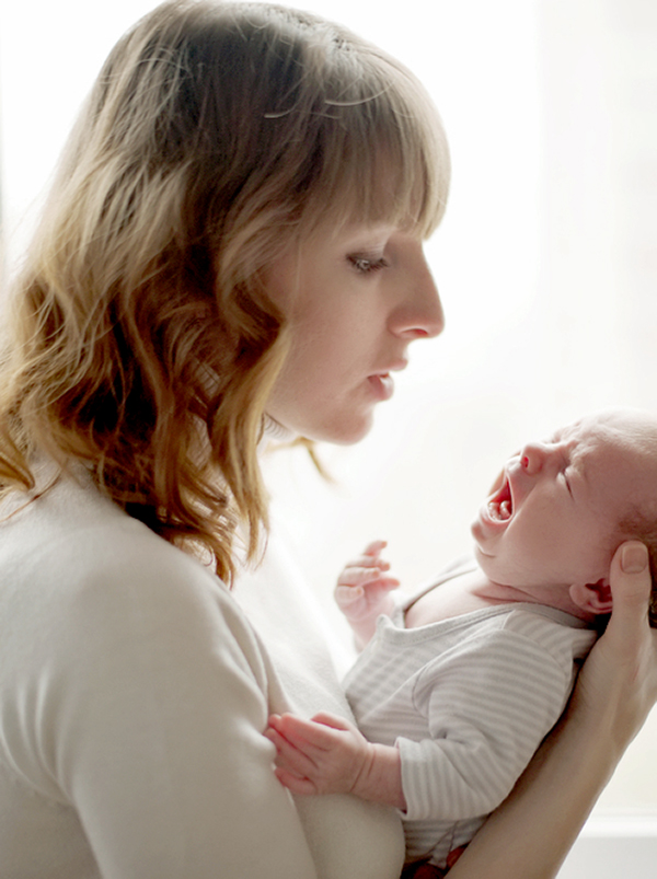 Mother comforting colicky infant